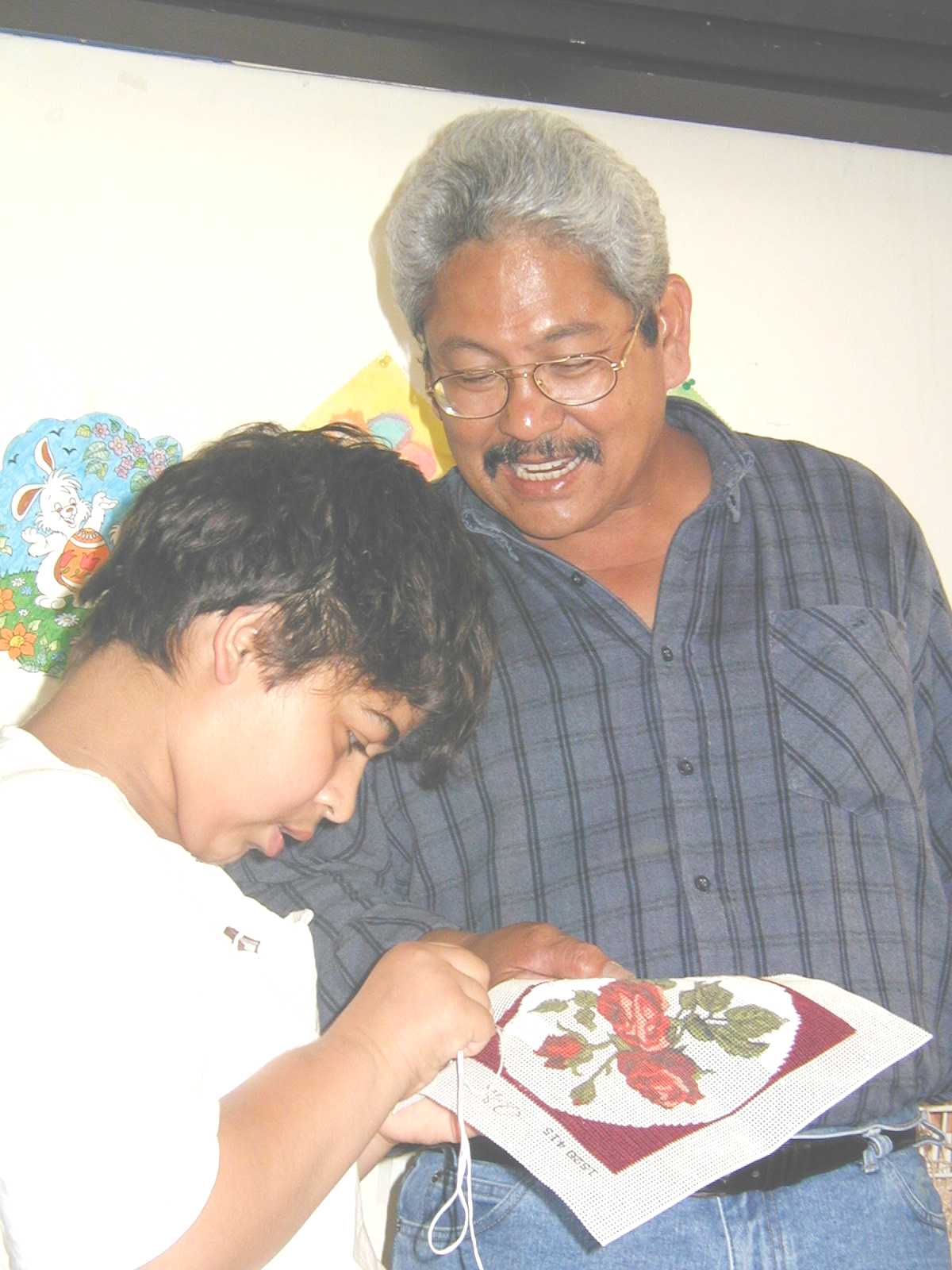 Frank Mendiola admires a child from the sewing class, Barcs, Hungary.
